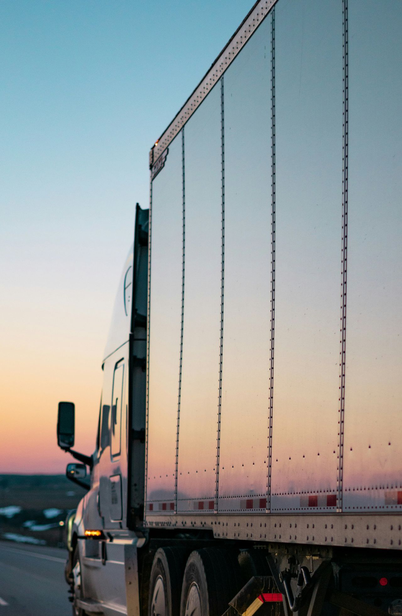 white freight truck on road during daytime